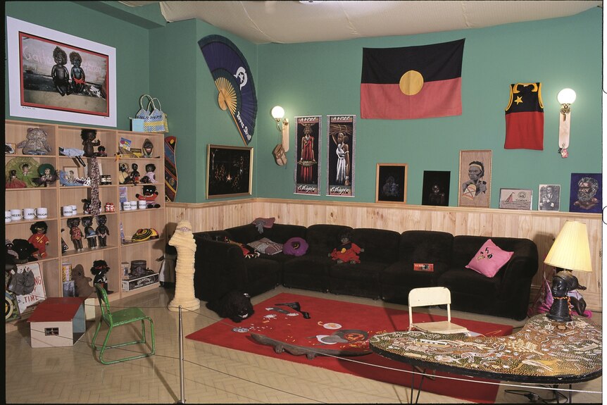 Installation view of exhibition Destiny Deacon: Walk & don't look blak, the artist's loungeroom filled with Aboriginalia recreat