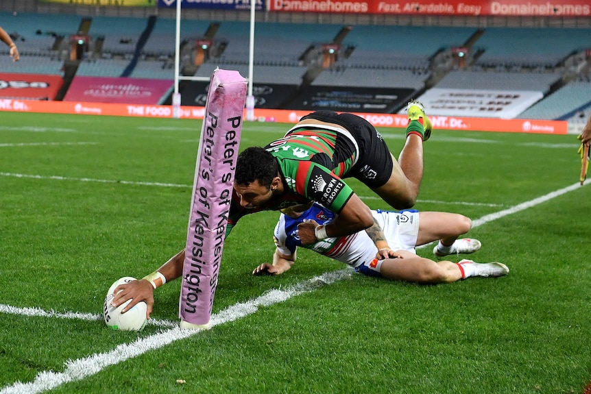 South Sydney Rabbitohs player Alex Johnston dives in to score a try against the Newcastle Knights
