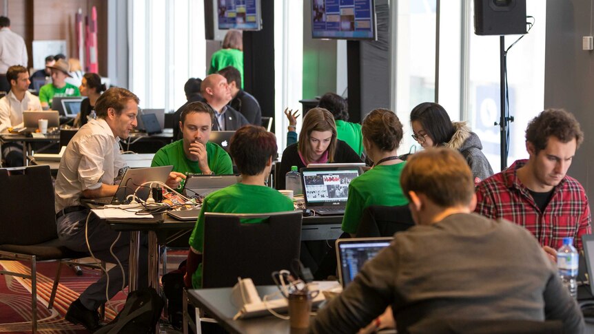 Hackathon teams sit in workshops