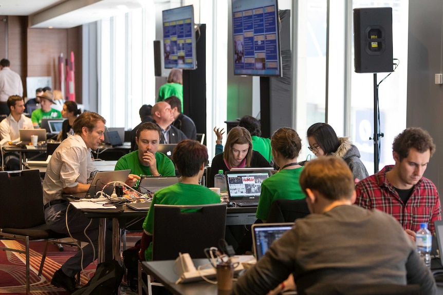 Hackathon teams sit in workshops