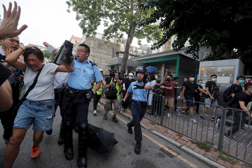Police scuffle with protesters in Hong Kong.