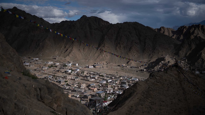 A shot taken from above shows Leh covered with prayer flags.