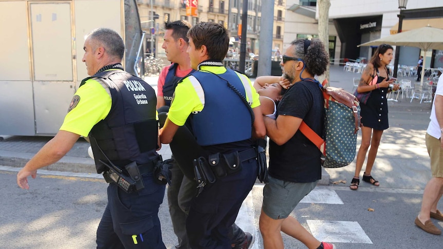 Police carry an injured person.