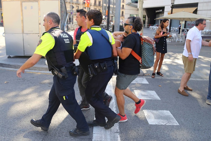 Police carry an injured person.