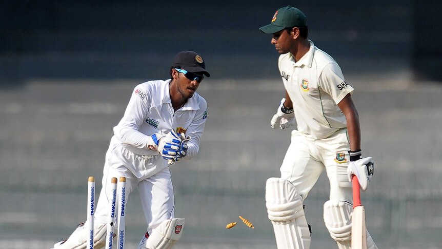 Sri Lankan wicket-keeper Dinesh Chandimal stumps Bangladesh batsman Sohag Gazi in Colombo.