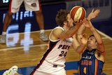 Big Cats ... Perth's Jesse Wagstaff shoots over Adelaide defender Greg Hire on his way to 22 points.