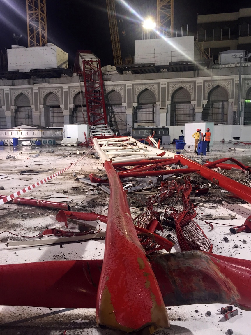 Emergency teams stand next to the collapsed crane in Mecca