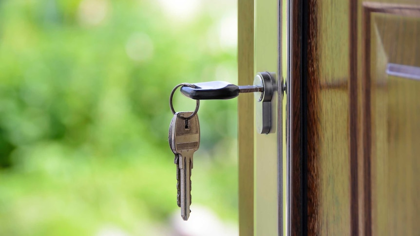 Keys rang from lock, in a front door.