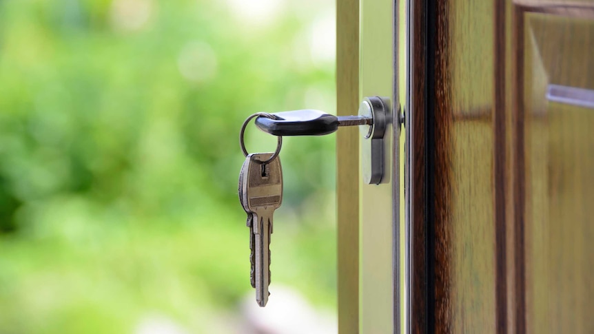 Keys rang from lock, in a front door.