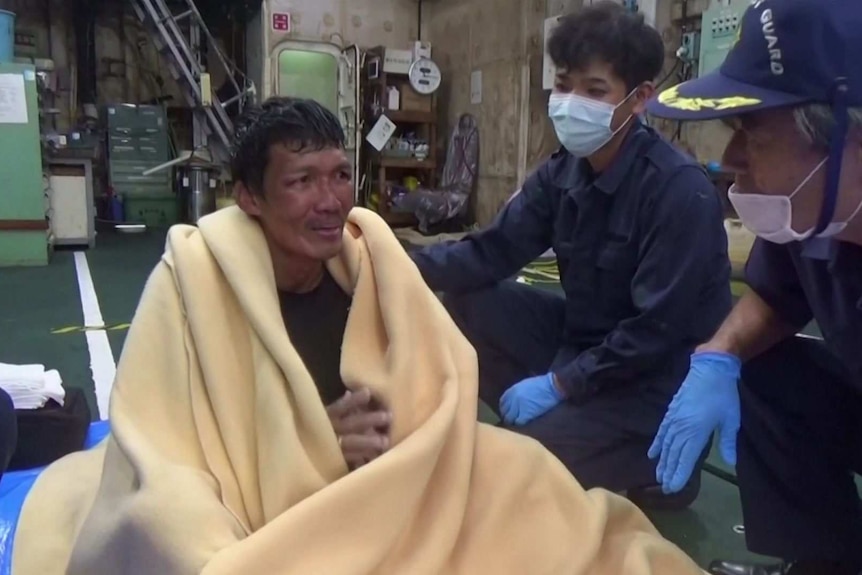 A rescued man in a blanket.