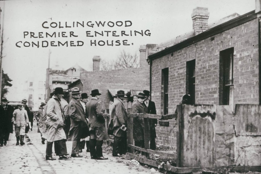 A group of men enter a dilapidated building