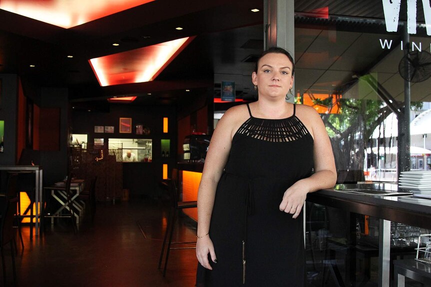 A woman outside a bar entrance