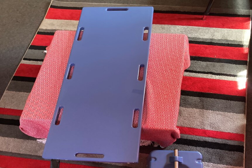 A long plate is connected to a box which powers the cooling operation