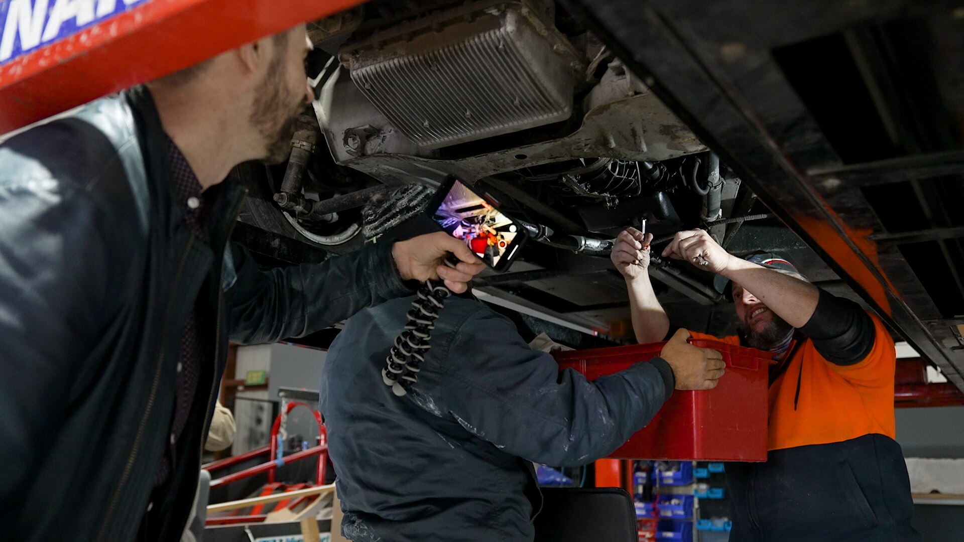 Ché Baker filming Mark Hemmingsen work on his DeLorean 