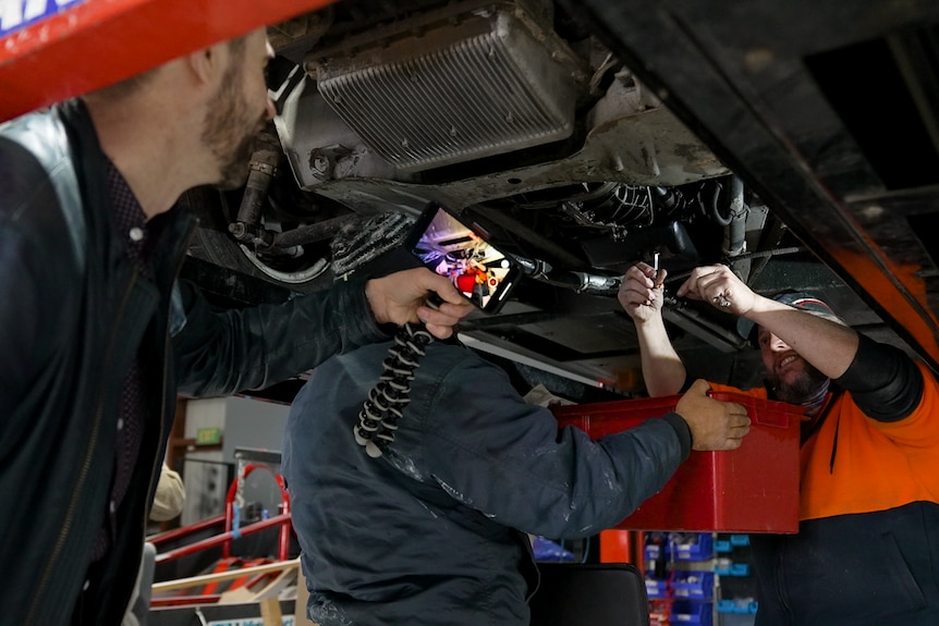 Ché Baker filming Mark Hemmingsen work on his DeLorean 