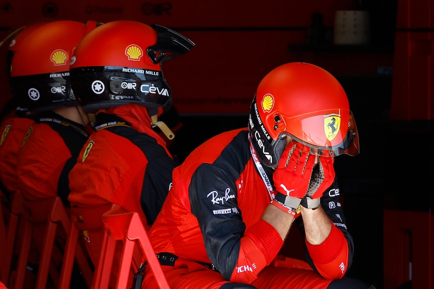 Ferrari mechanics react after Ferrari driver Charles Leclerc crashes