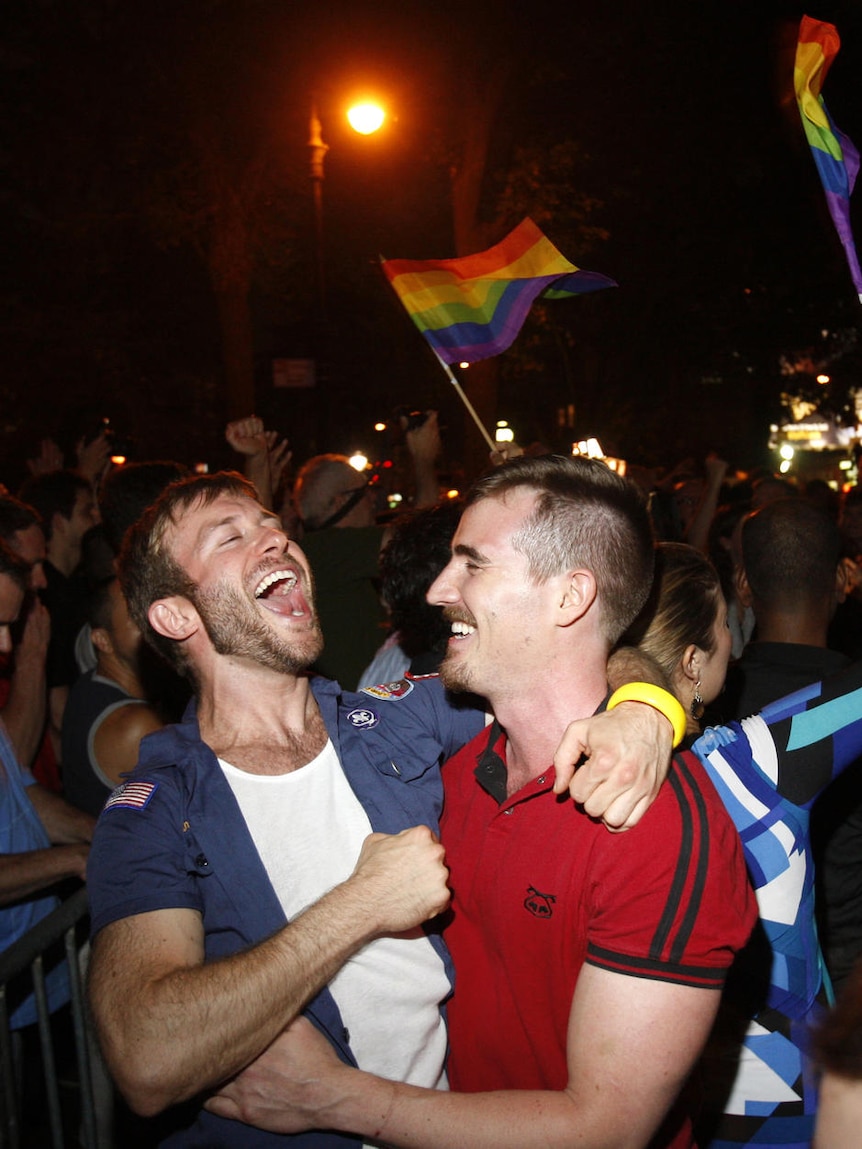 People celebrate after the New York Senate passed a bill legalising gay marriage