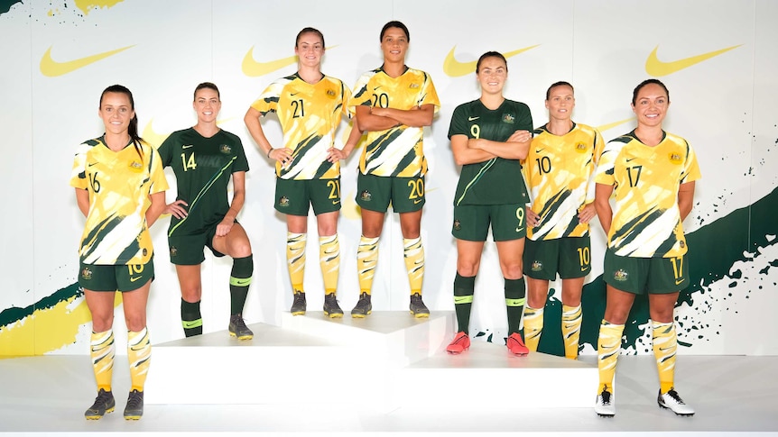 Matildas players pose wearing the new World Cup kit.