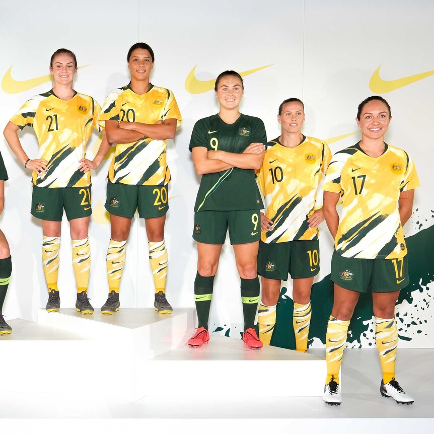 Matildas players pose wearing the new World Cup kit.
