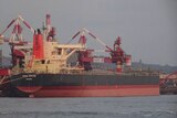 An iron ore bulk carrier at port.