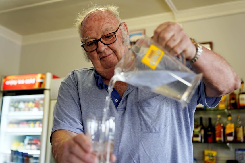 John Crowe pouring water