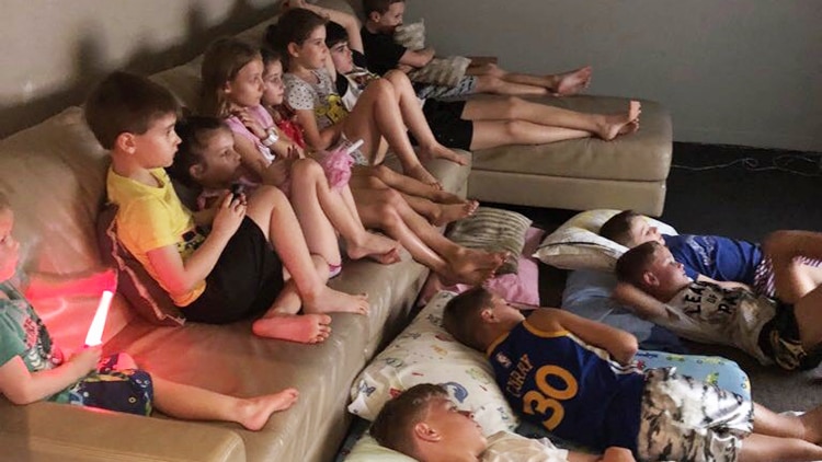 13 children lie on a couch and loungeroom floor in house of family that took in more than 60 neighbours.