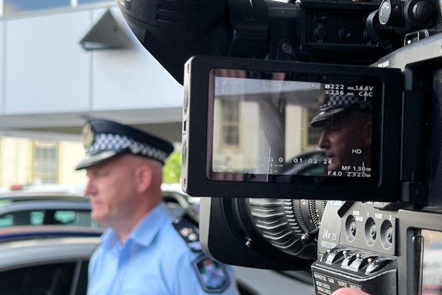 View from a cameraman of a policeman.