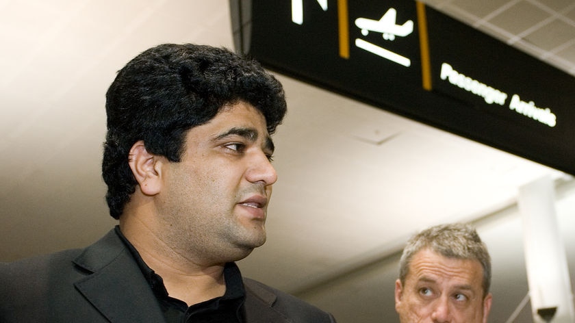 Imran Siddiqui talks with the media with solictor Peter Russo in background at airport.