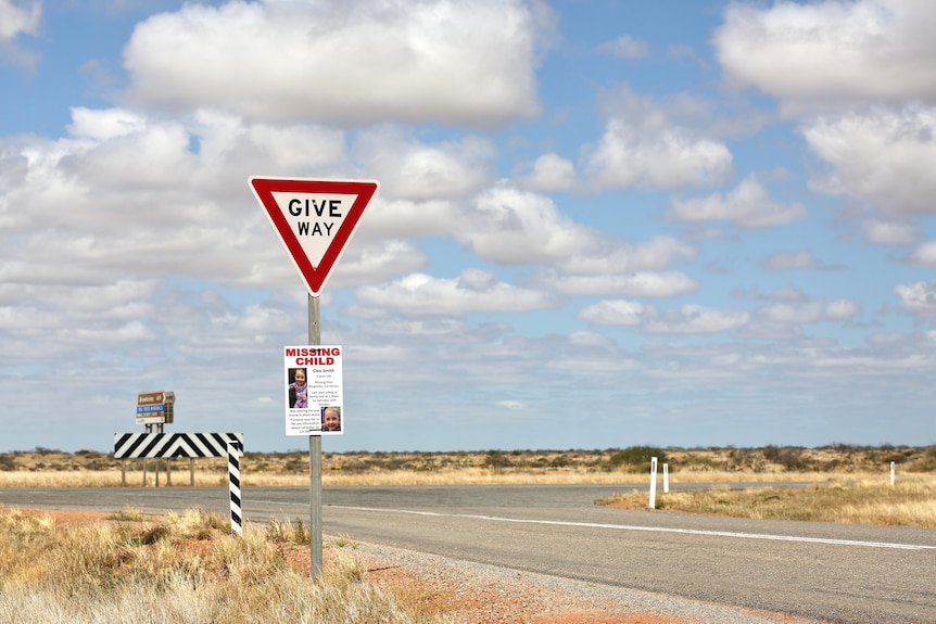 A photo of the Blowholes Road intersection with a give way sign in the foreground.