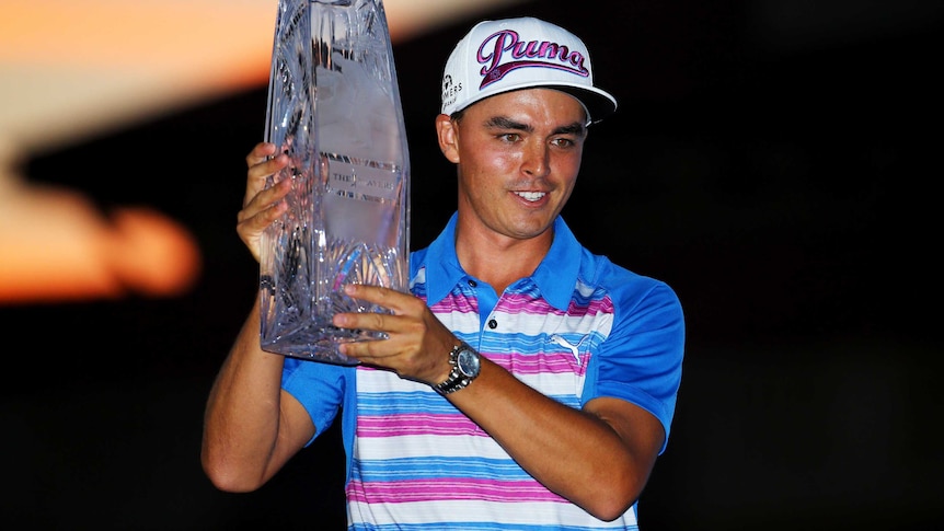 Rickie Fowler poses with Players Championship trophy