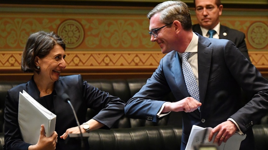 Gladys Berejiklian and Dominic Perrottet elbow bump in the Lower House.