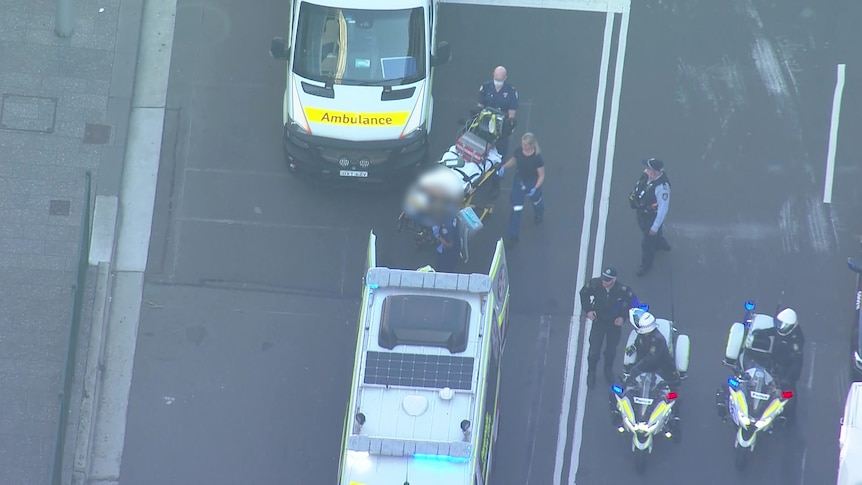 a person stretchered to an ambulance at bondi junction
