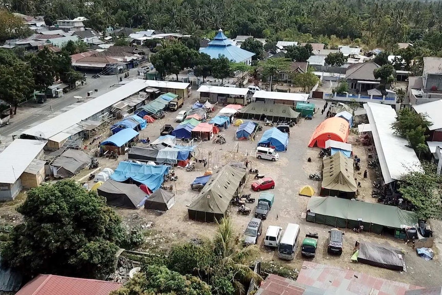 Tents are set up in the middle of a car park