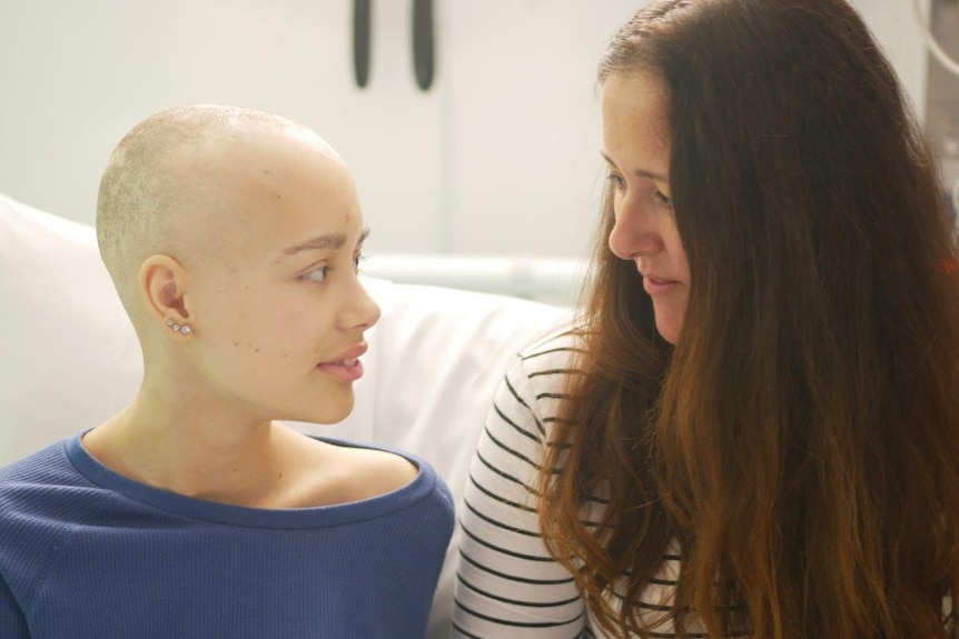 Sienna Martucci sitting looking at her mother Natalie in hospital.