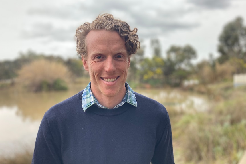 A man in front of a lake.