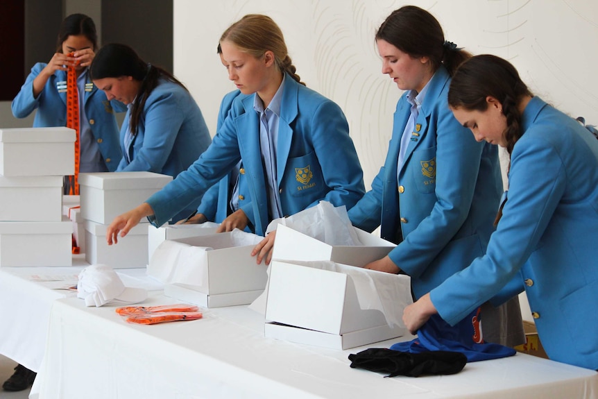 School students wrap gift boxes