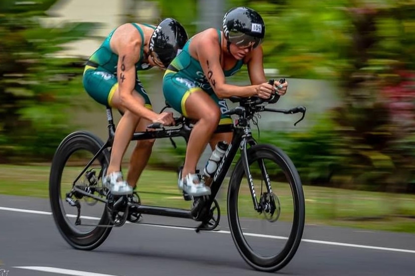 Katie Kelly and Briarna Silk on a tandem bike during a para-triathlon.