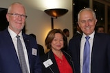 Justin Milne, Michelle Guthrie and Malcolm Turnbull stand together for a photograph at an evening function.