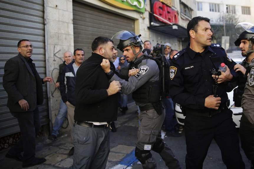 An Israeli officers scuffles with a Palestinian protester near the Old City on Saturday.
