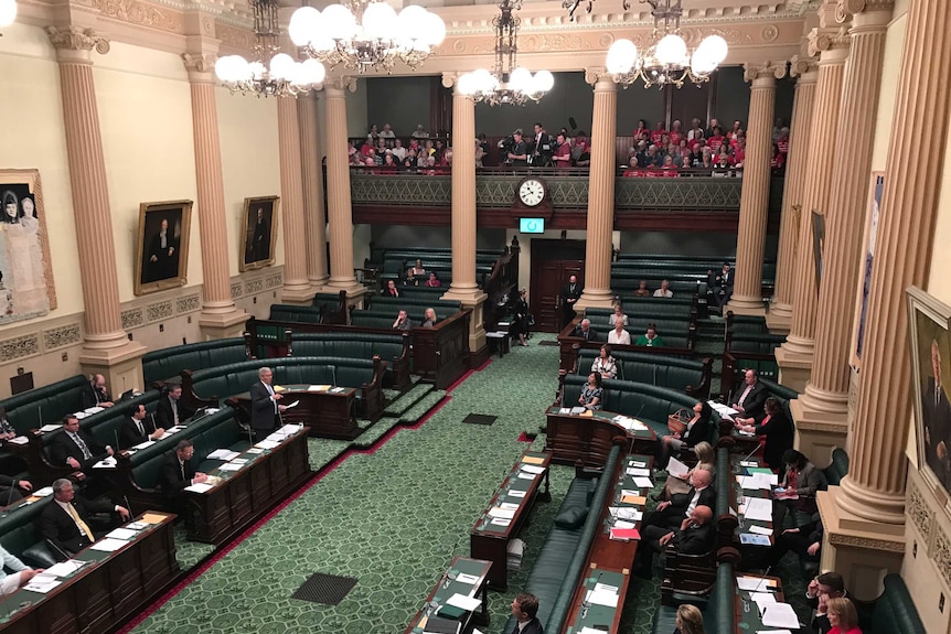 People watch on from the public gallery.