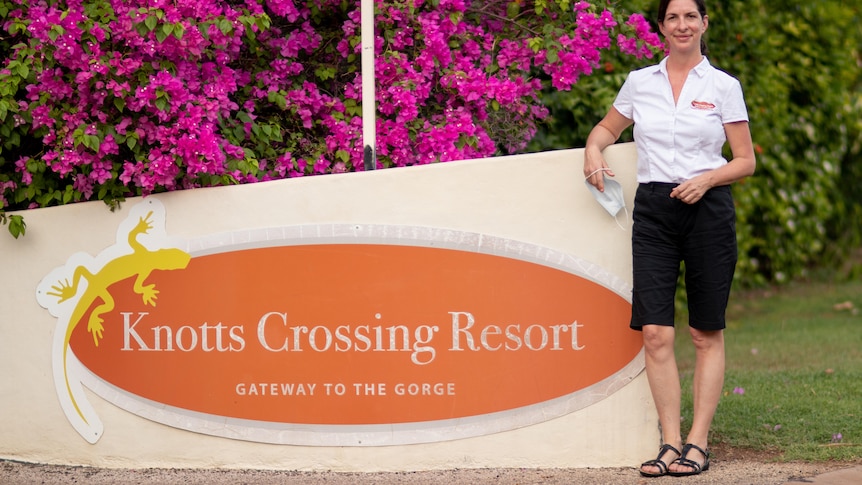 Knotts Crossing Resort and Manager Jo Pace stands next to the sign outside her resort.