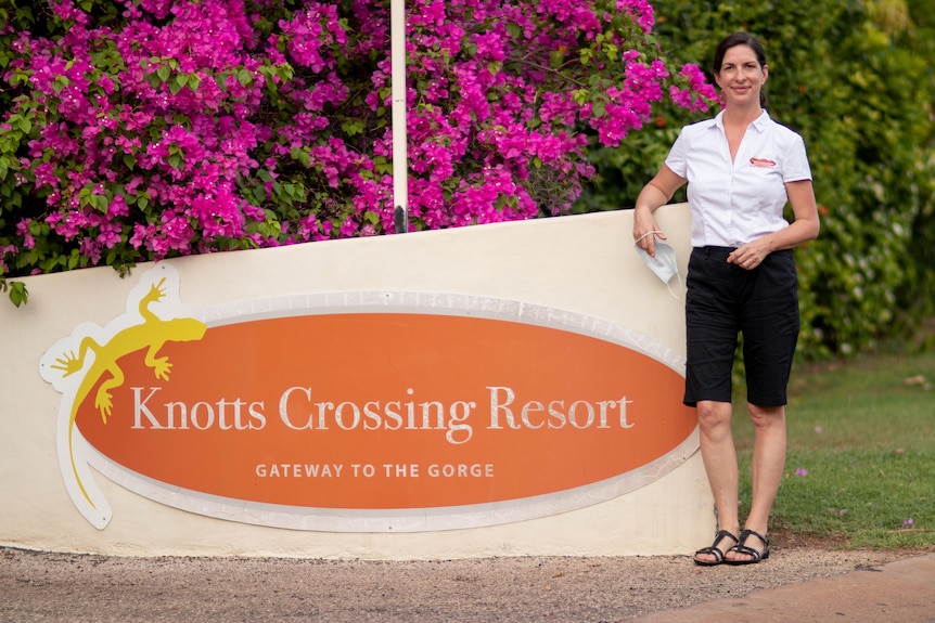 Knotts Crossing Resort and Manager Jo Pace stands next to the sign outside her resort.