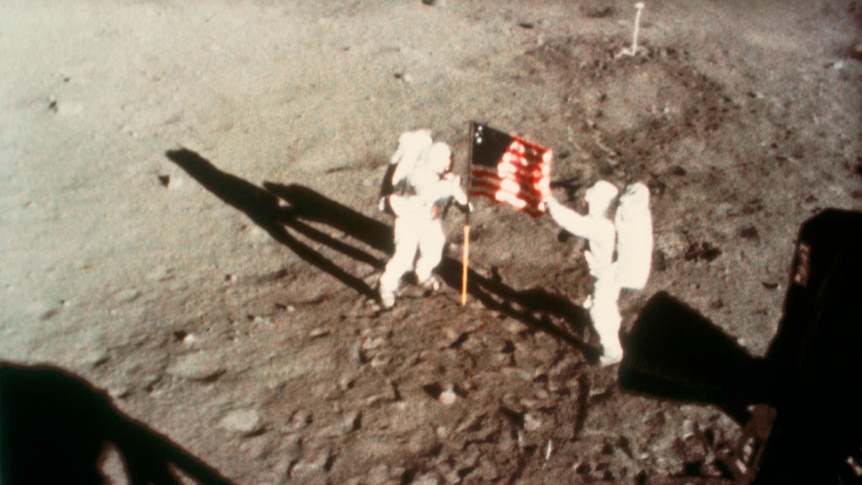 Neil Armstrong and Buzz Aldrin unfurl the American flag on the moon in June 1969