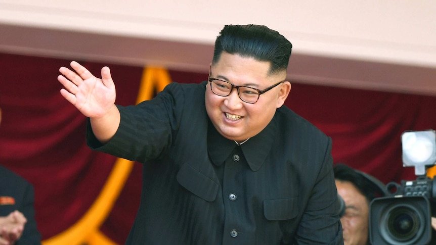 North Korean leader Kim Jong Un waves during a parade for the 70th anniversary of North Korea's founding day.