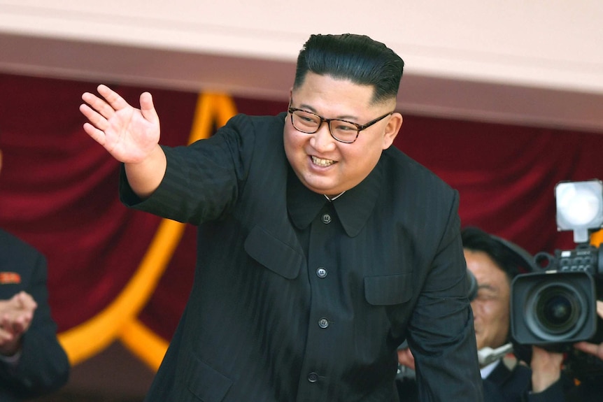 North Korean leader Kim Jong Un waves during a parade for the 70th anniversary of North Korea's founding day.