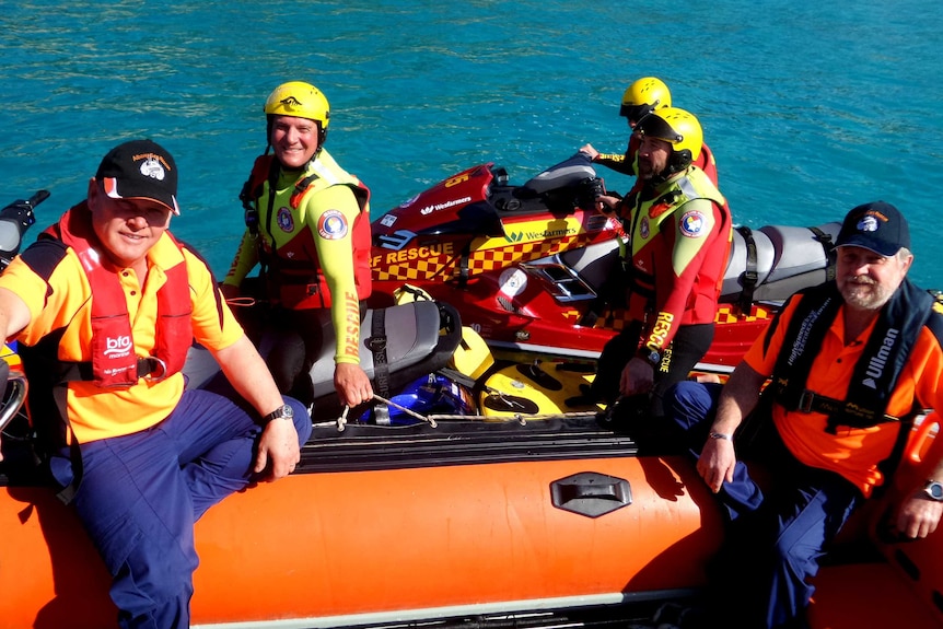 Volunteers from the Albany Surf Life Saving Club and the Albany Sea Rescue Squad sit in a boat and on jet skis.