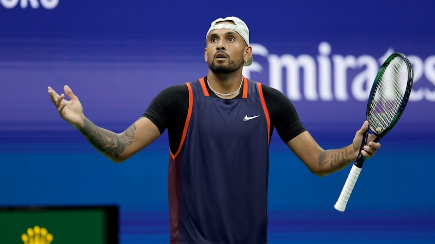 Australia's Nick Kyrgios stands on the court during a match with his arms spread wide, looking up in disbelief. 