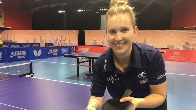 A young woman playing table tennis