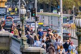Pedestrians on Princes Bridge in Melbourne