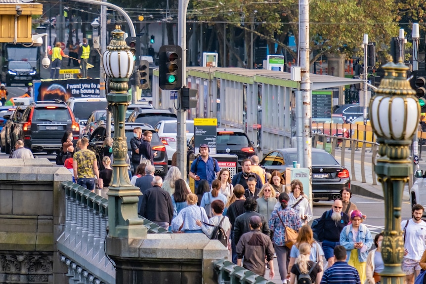 A picture of pedestrians walking over a bridge in Melbourne